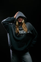 Person wearing a blue hoodie with text on a black background