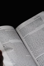 Open book with text on a black background