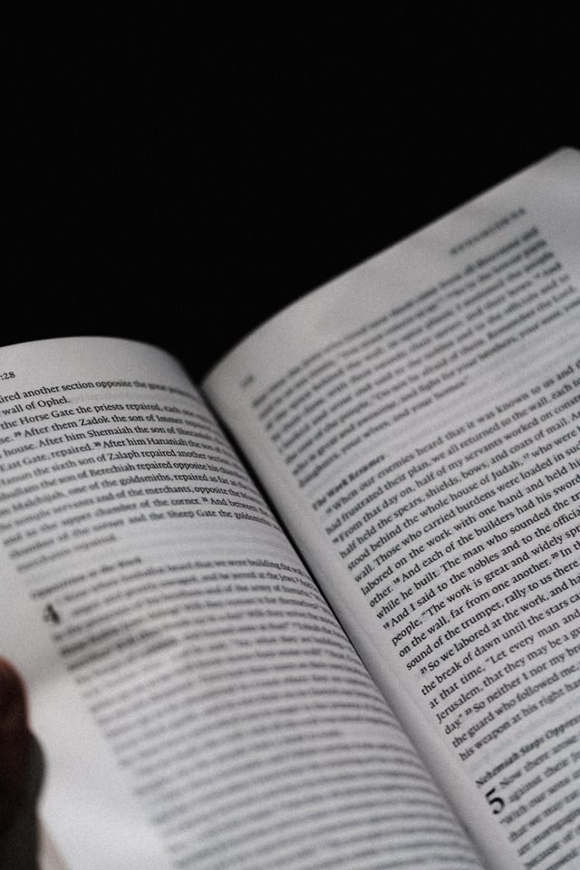 Open book with text on a black background