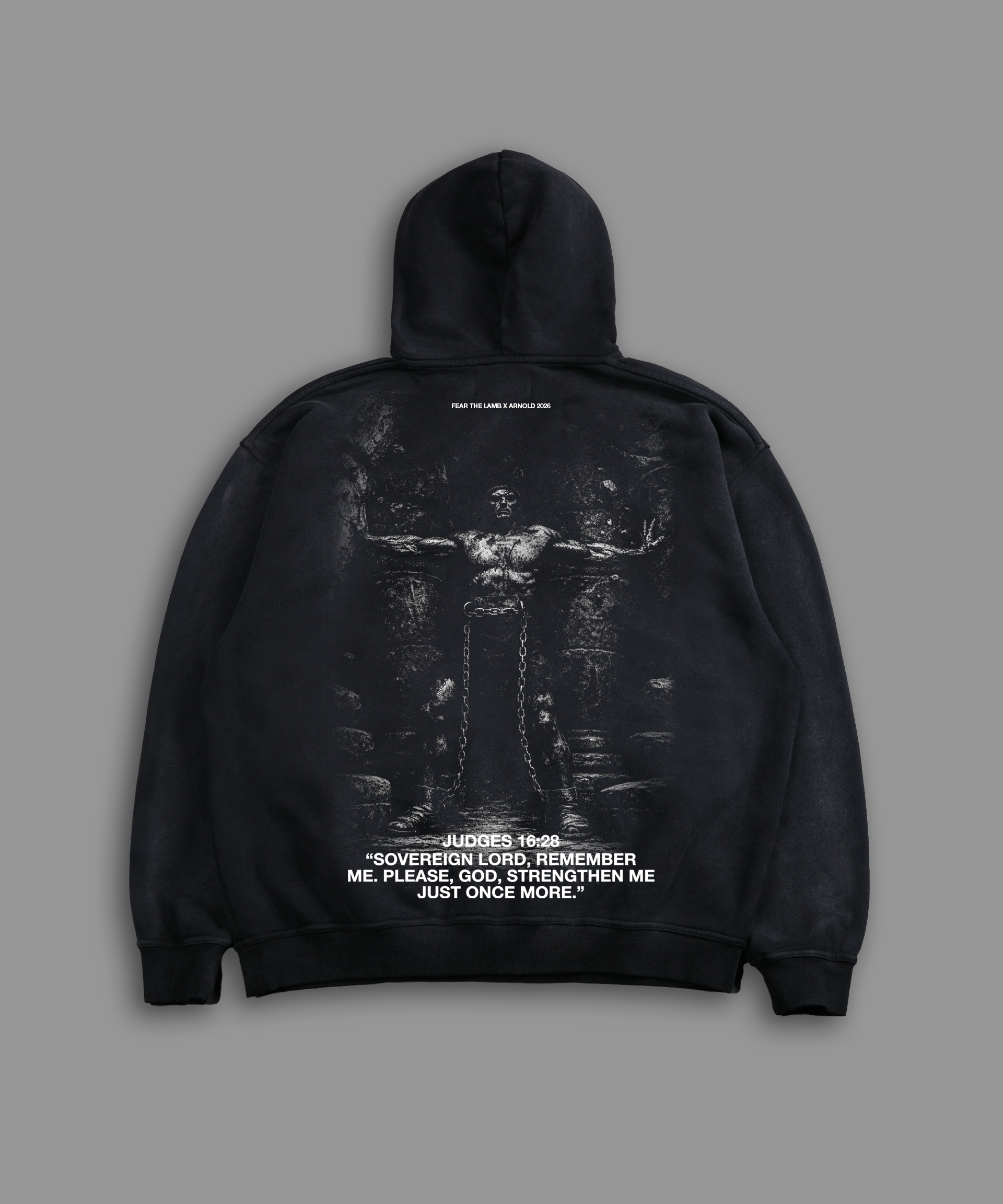 Black hoodie with graphic design on the back against a gray background